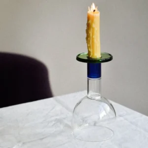 Wine candle glass with green and blue accents, featuring a candle on top and showcasing a taverna-style design.